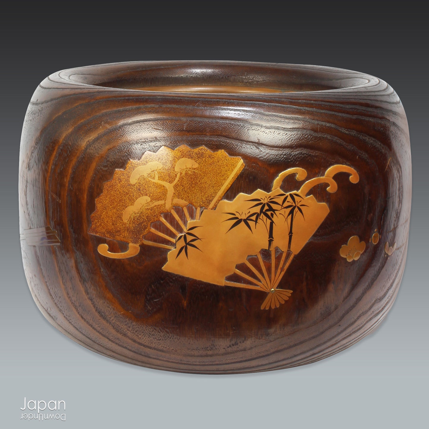 Infuse your home with the charm of Japanese tradition with this stunning antique hibachi heating pot. Adorned with intricate gold makie lacquer fans, this lovely piece seamlessly blends artistry and functionality, making it perfect as a decorative object, vase, or planter. A rare and beautiful find for those who appreciate vintage decor with a touch of elegance and history.