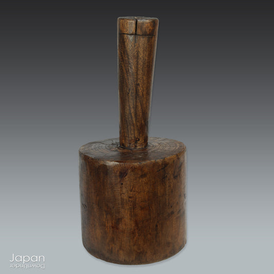 Bring a touch of lived history into your home with this antique Japanese Kinuta mallet - a striking relic of traditional craftsmanship, worn by time and softened by use. Once a familiar tool in rural Japan, it now stands as a compelling sculptural piece, full of character and cultural resonance.