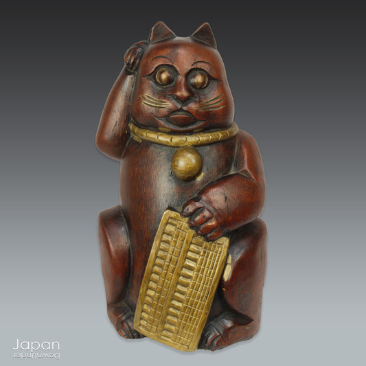 Add a touch of vintage charm to your home or office with this quaint Japanese maneki neko lucky cat. Crafted from bamboo, this larger sized cat,holding an abacus, is believed to beckon in wealth and good luck. Perfect for infusing positive energy and a touch of nostalgia into any space.