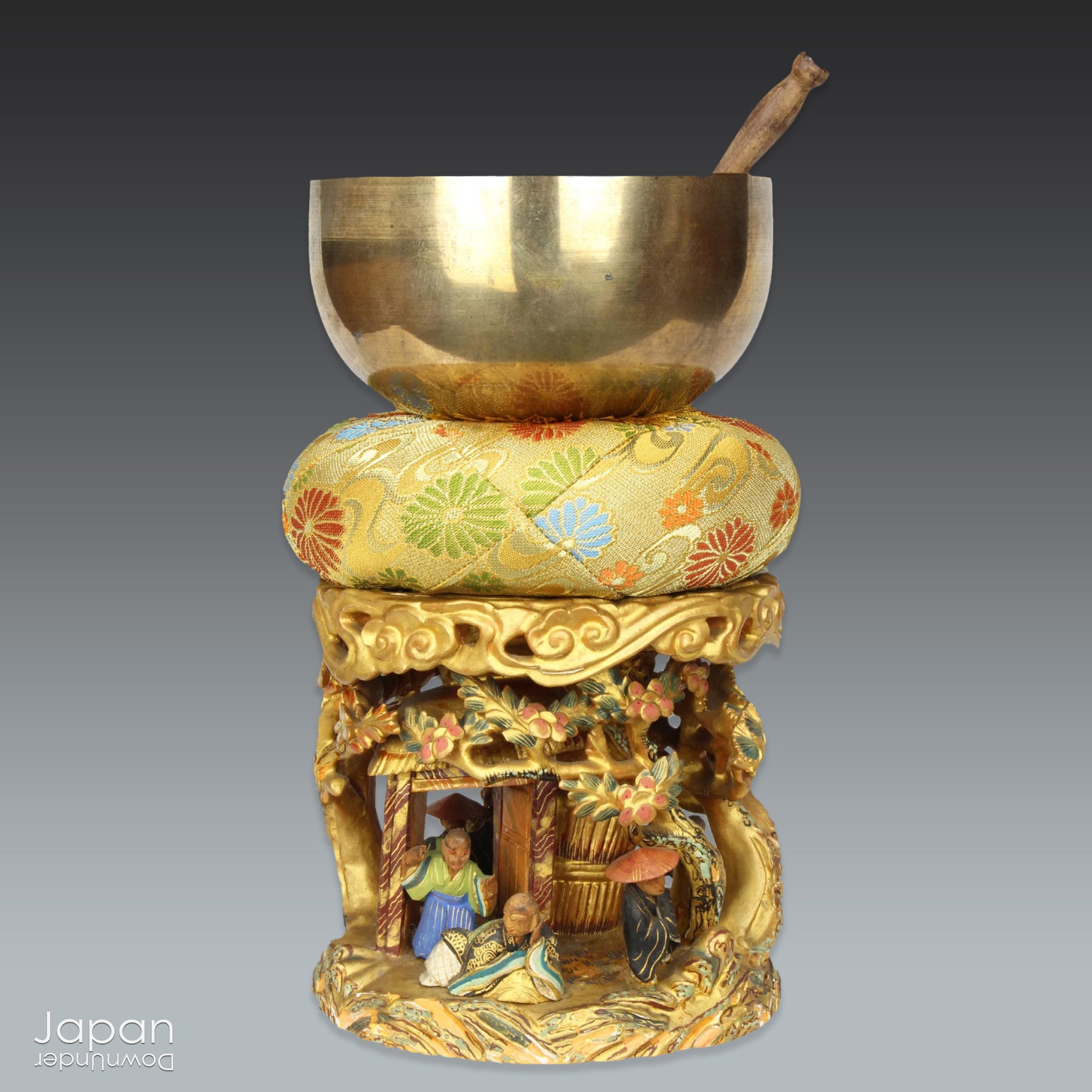 An 1800’s Buddhist altar singing bowl, harmoniously displayed on a traditional intricately carved custom order stand. Complete with a luxurious brocade cushion, this set exudes timeless elegance and spiritual significance.