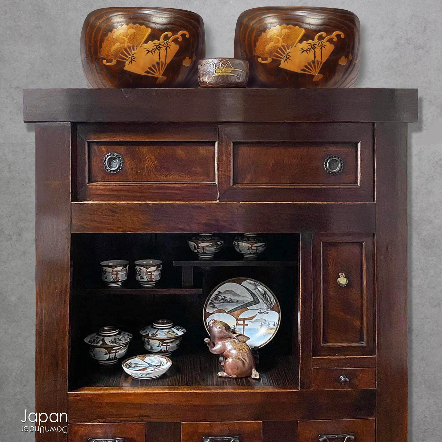 Infuse your home with the charm of Japanese tradition with this stunning antique hibachi heating pot. Adorned with intricate gold makie lacquer fans, this lovely piece seamlessly blends artistry and functionality, making it perfect as a decorative object, vase, or planter. A rare and beautiful find for those who appreciate vintage decor with a touch of elegance and history.