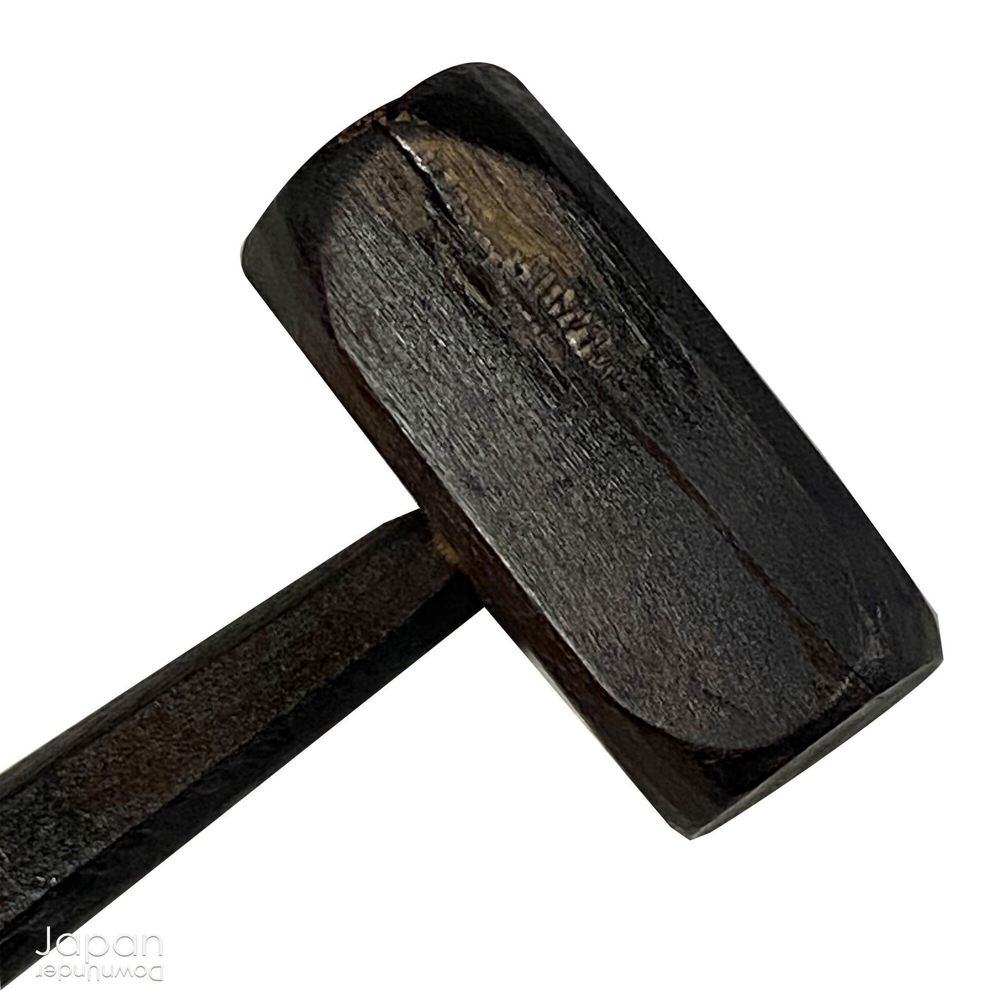 A vintage Buddhist temple gyoban; a  plank of wood shaped like a fish.  It is carved from   wood. The scales, big eye and fin, etched  into the wood,  give the fish form. There is a  round pearl in the fish mouth,  symbolizing unity.