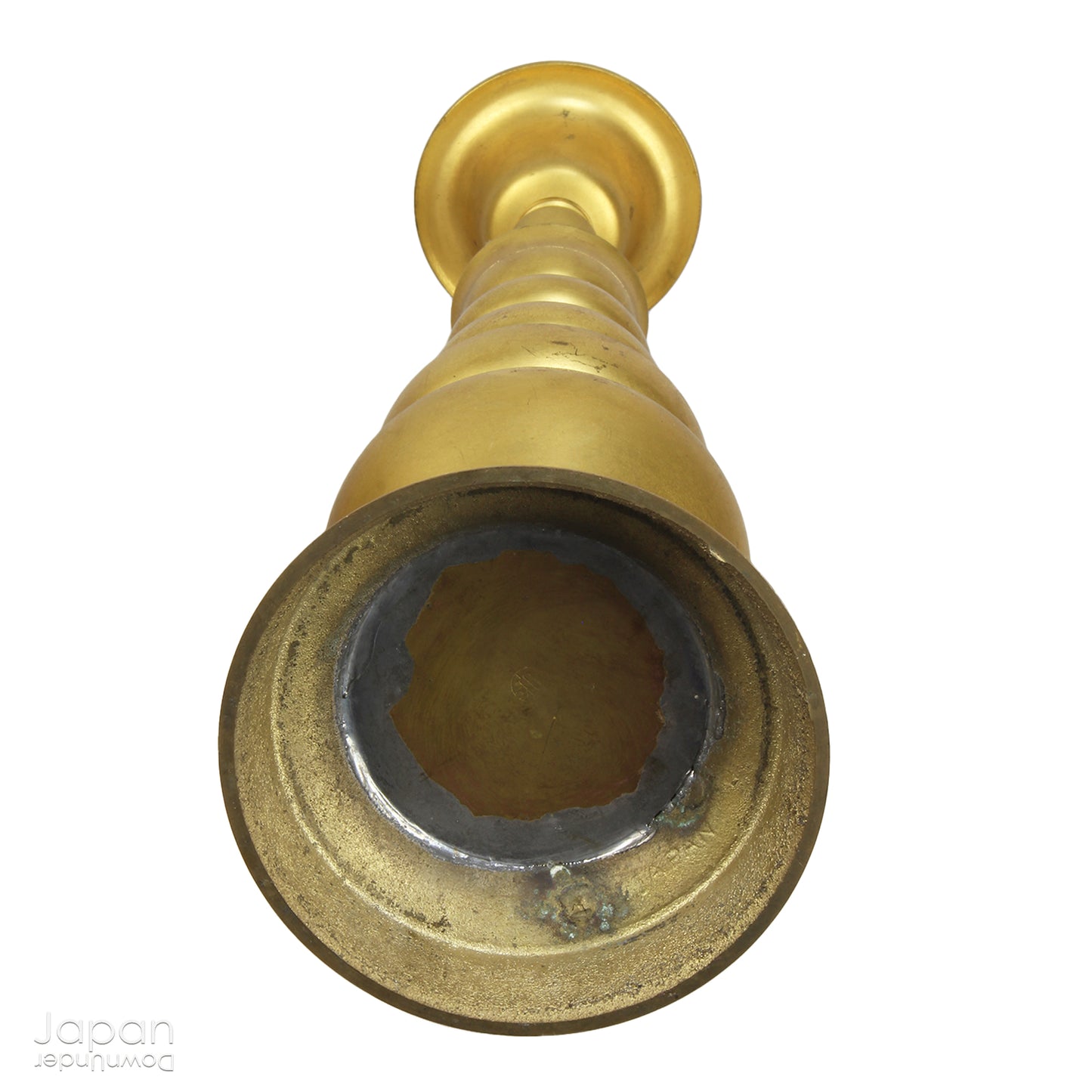 An antique Buddhist temple candle holder.    The gilded brass candle holder is a cylindrical shape, formed of spheres,  gradually decreasing in size as they move upwards. Just below the candle cup hang a pair of Japanese komainu, or lion dogs.