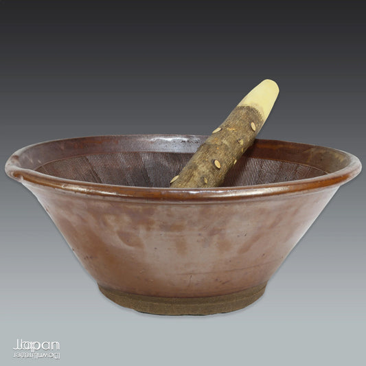 Elevate your home decor with this stunning, large antique Japanese mortar and pestle, a unique piece of history and craftsmanship that brings a rich cultural touch to any space. This vintage stoneware folk art item is perfect for those who appreciate rare, one-of-a-kind treasures and are drawn to the beauty of traditional craftsmanship. A true must-have for collectors of Japanese artifacts.