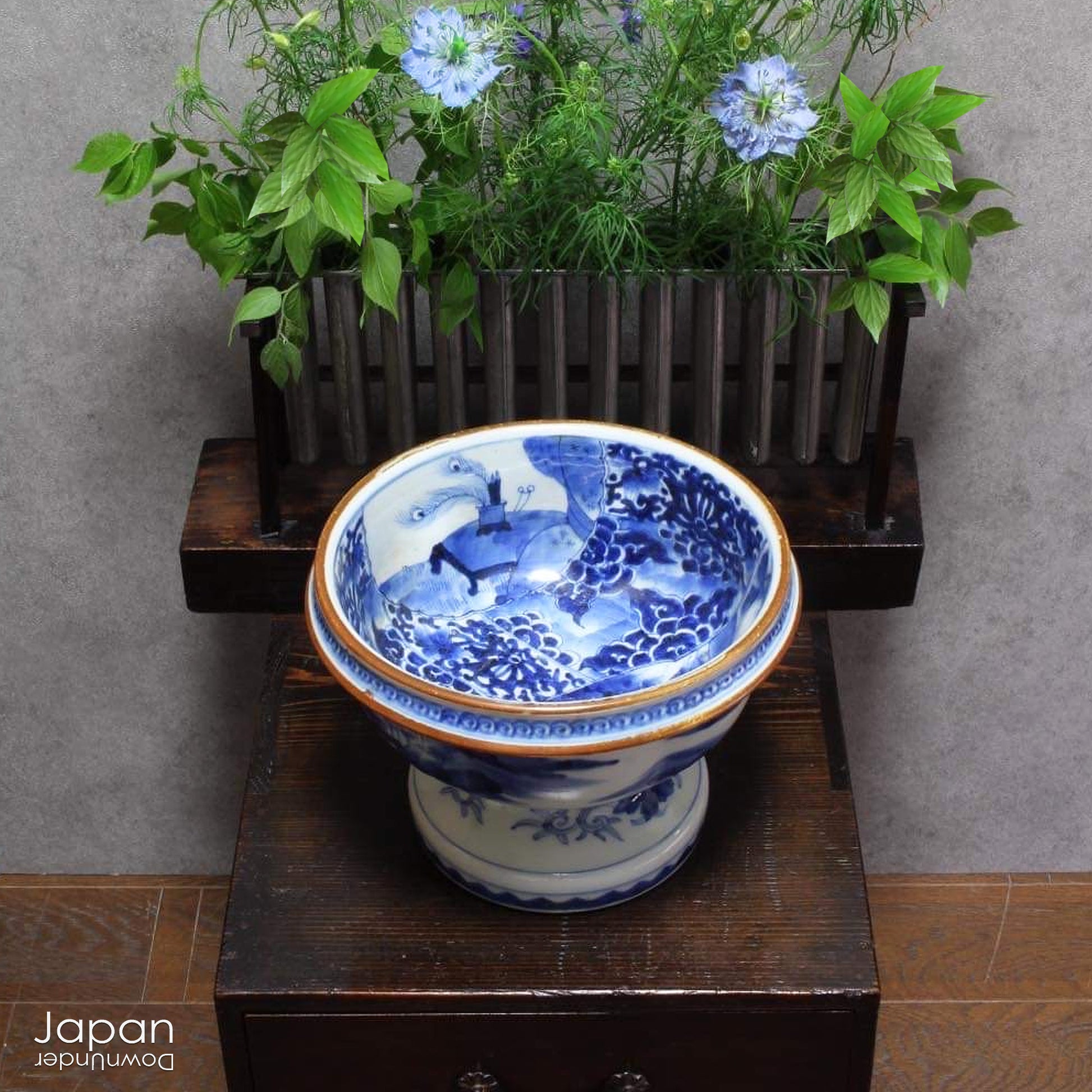 Elevate your home decor with this stunning antique blue and white Imari bowl on a stand. This rare and elegant piece features intricate hand-painted designs, both inside and out, showcasing craftsmanship that will captivate and enchant. Add a touch of sophistication and timeless beauty to any space with this exceptional treasure.