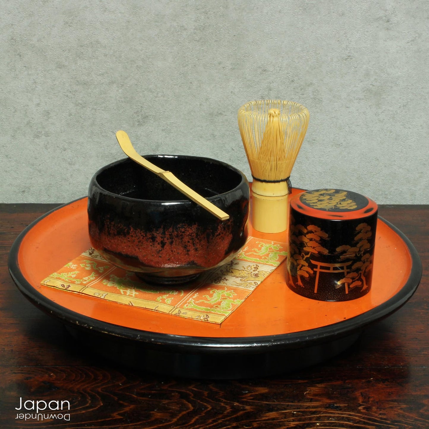 Elevate your tea experience with this stunning vintage black raku ware matcha tea bowl, a timeless work of art that brings both beauty and sophistication to every sip. Handcrafted in Kyoto, Japan, this elegant bowl features a striking contrast between the glossy black glaze and subtle reddish-brown accents that emerge randomly across the surface - each one a testament to the artistry and uniqueness of the raku firing process.