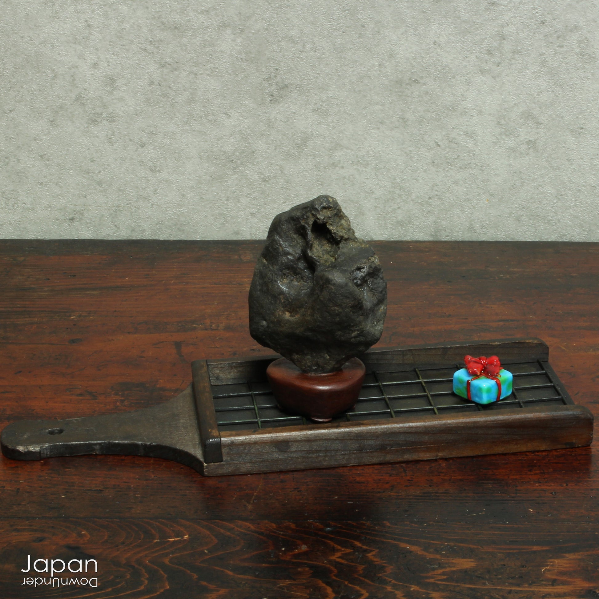 Gracefully poised atop a hand-carved wooden daiza (stand), this suiseki stone emanates a quiet, contemplative energy - making it an ideal centerpiece for spaces devoted to mindfulness, reflection, or artistic inspiration.