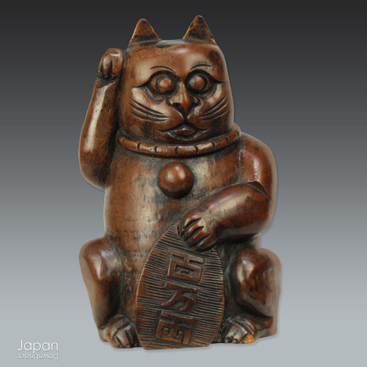 Add a touch of vintage charm to your home or office with this quaint Japanese maneki neko lucky cat. Crafted from bamboo, this larger sized cat holding an old Japanese koban coin is believed to beckon in wealth and good luck. Perfect for infusing positive energy and a touch of nostalgia into any space.