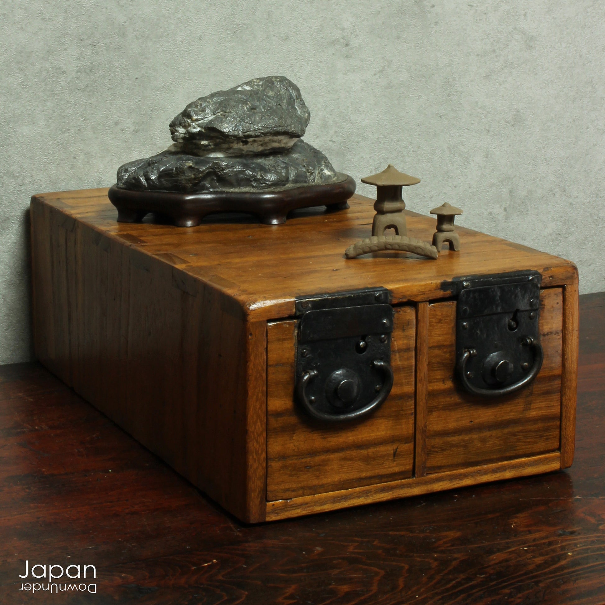 Add a touch of history and heritage to your desk with this antique Japanese medicine chest -  a beautifully rustic piece that blends traditional folk art with everyday functionality. Once used in a centuries-old system of home-based healthcare, this small storage box now offers a unique and charming way to organize your workspace.