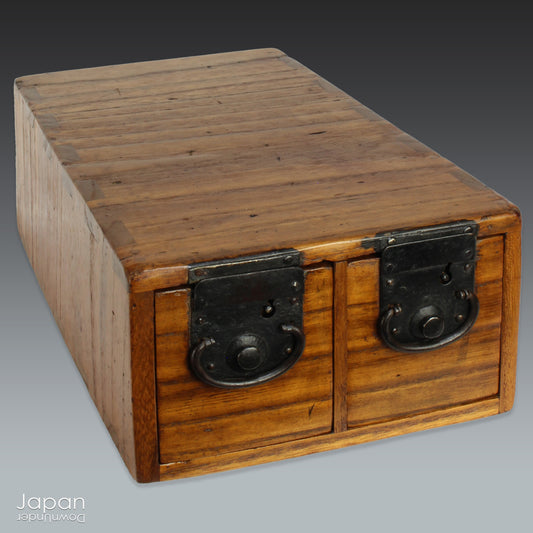 Add a touch of history and heritage to your desk with this antique Japanese medicine chest -  a beautifully rustic piece that blends traditional folk art with everyday functionality. Once used in a centuries-old system of home-based healthcare, this small storage box now offers a unique and charming way to organize your workspace.