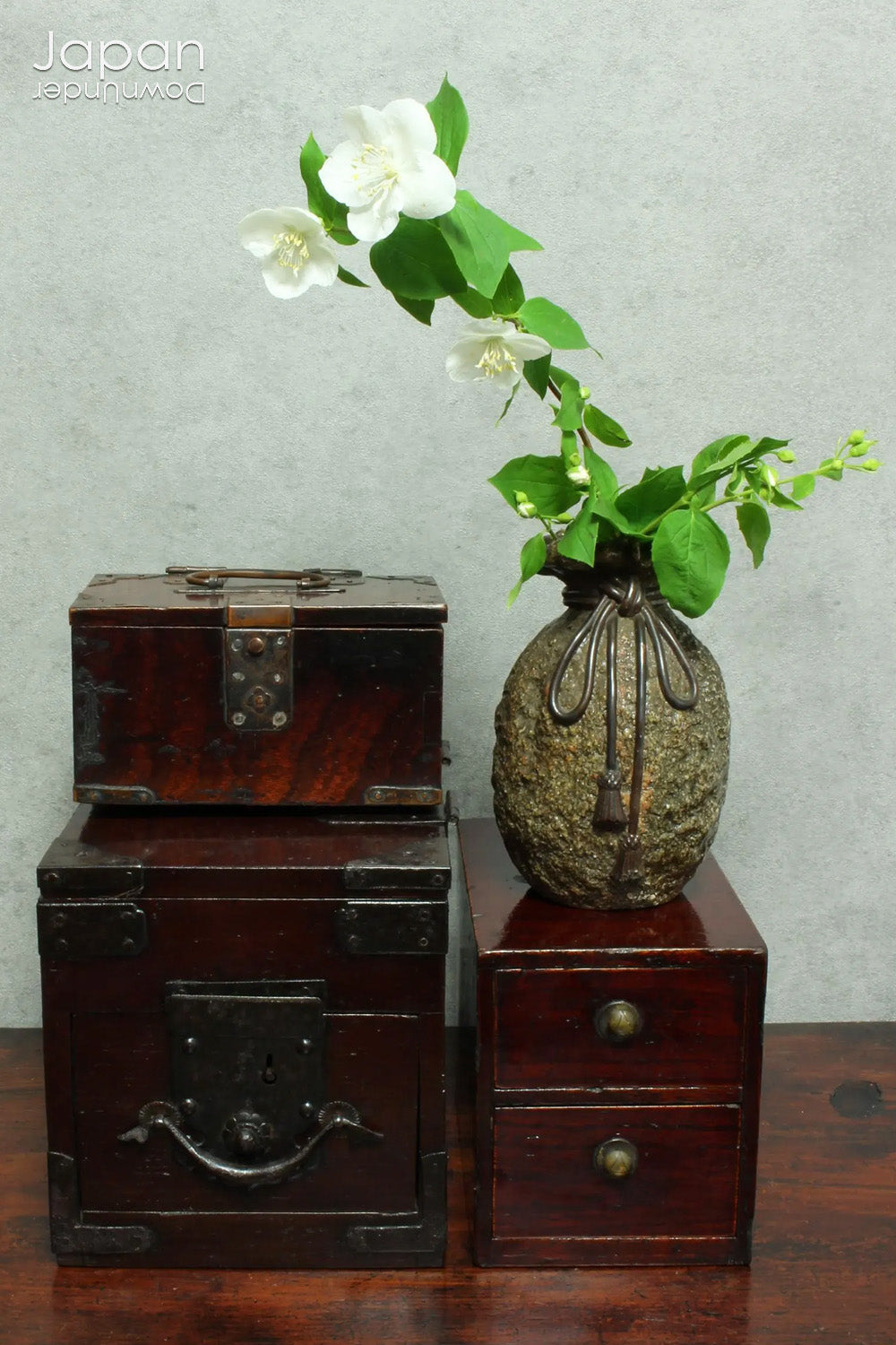 Discover a rare and beautifully aged treasure from the Meiji era (late 1800s) - a small Japanese wooden box that perfectly marries rustic charm with quiet sophistication. Originally designed with purpose and practicality at its core, this piece offers both functional storage and an understated aesthetic appeal, making it an ideal home for your cherished keepsakes or a striking accent in any space.