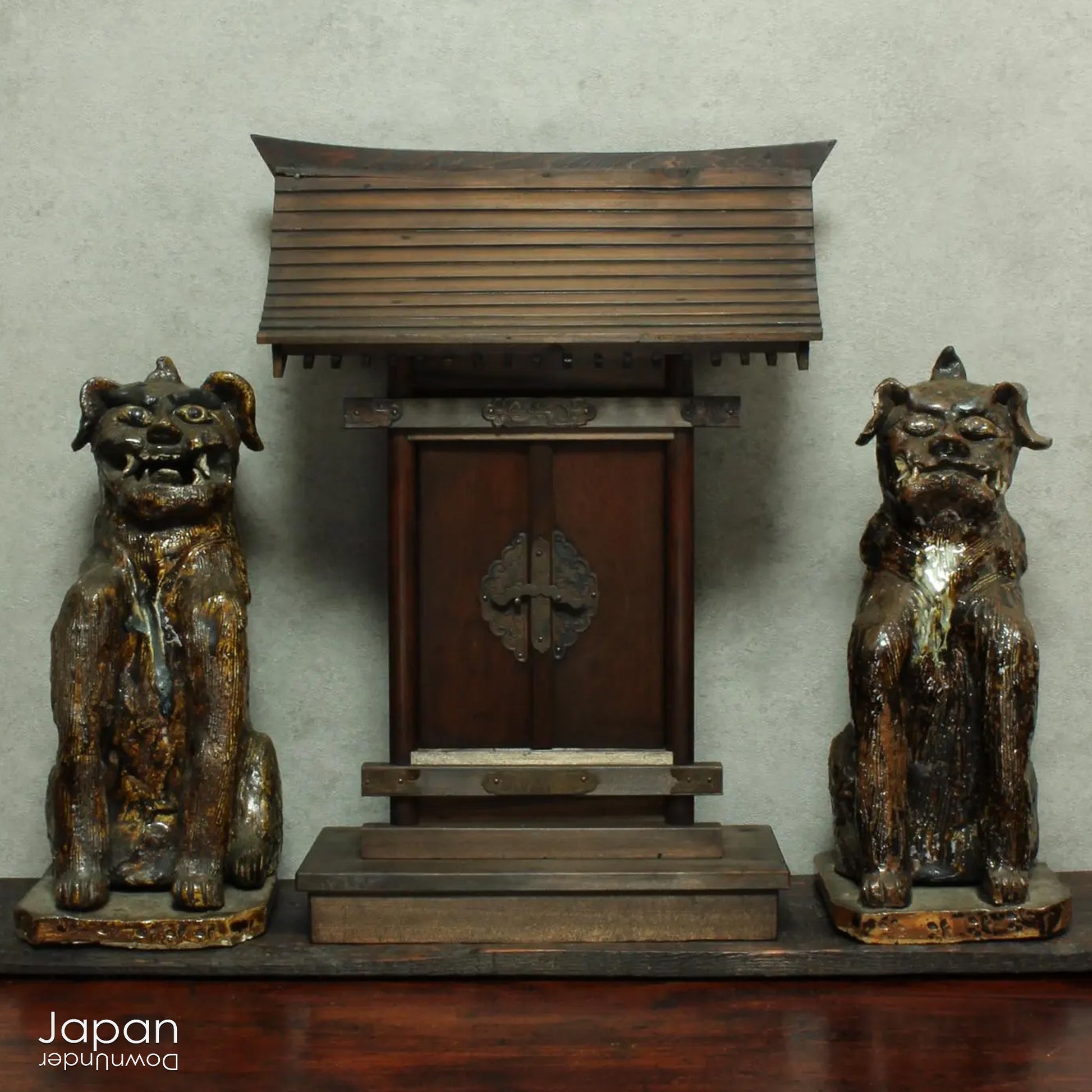 An enchanting duo of antique stoneware lion dogs, known as komainu. Believed to ward off evil, these guardians stand watch at the entrance of Shinto shrines, and will add a touch of mystique to your decor. Handcrafted with intricate details, the lion dogs are sure to bring a sense of protection and tradition to your space.
