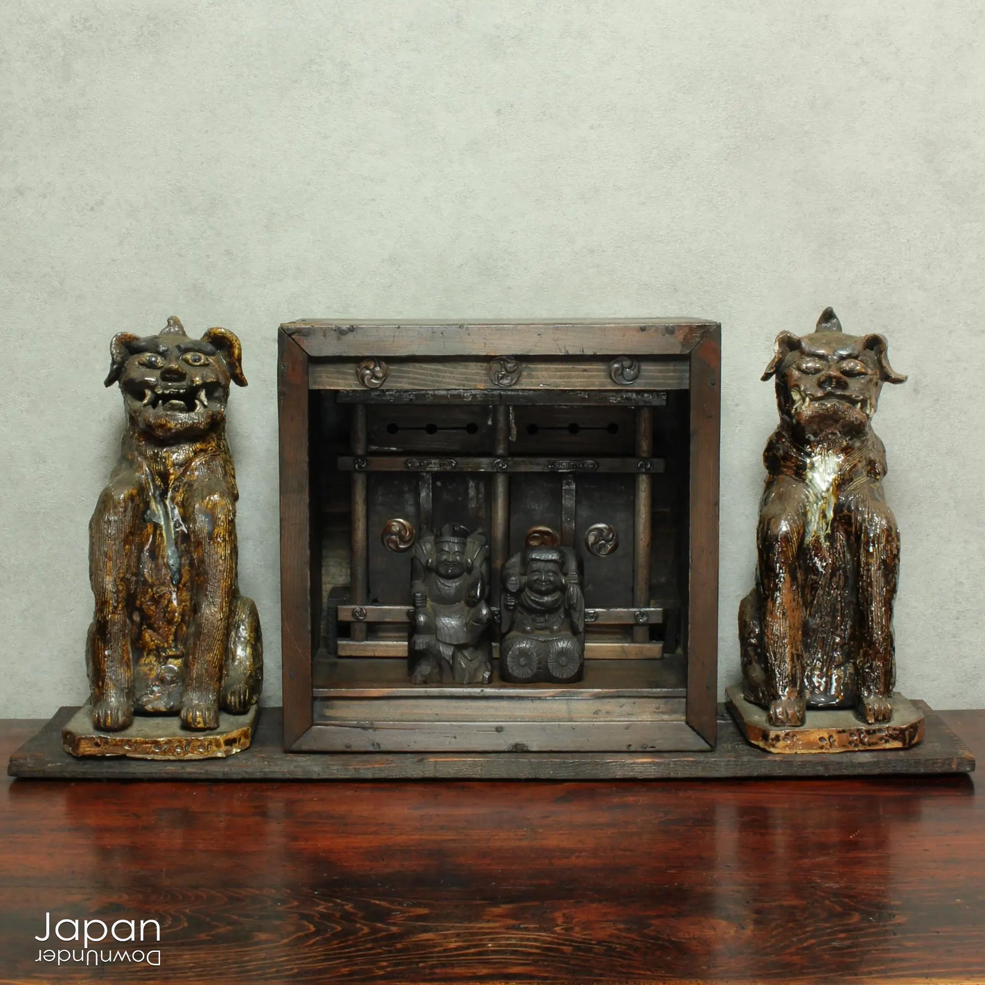 An enchanting duo of antique stoneware lion dogs, known as komainu. Believed to ward off evil, these guardians stand watch at the entrance of Shinto shrines, and will add a touch of mystique to your decor. Handcrafted with intricate details, the lion dogs are sure to bring a sense of protection and tradition to your space.