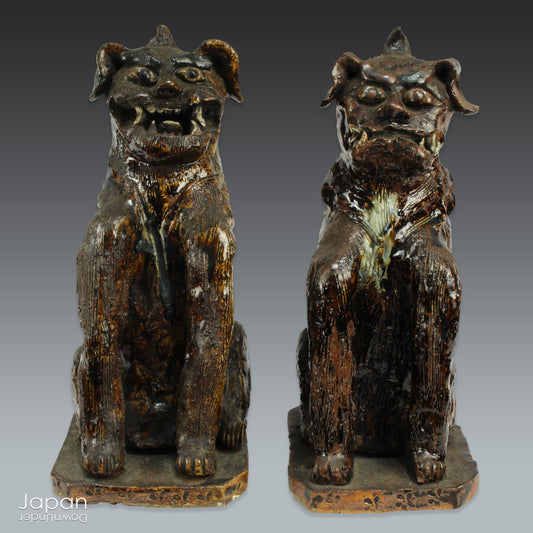 An enchanting duo of antique stoneware lion dogs, known as komainu. Believed to ward off evil, these guardians stand watch at the entrance of Shinto shrines, and will add a touch of mystique to your decor. Handcrafted with intricate details, the lion dogs are sure to bring a sense of protection and tradition to your space.