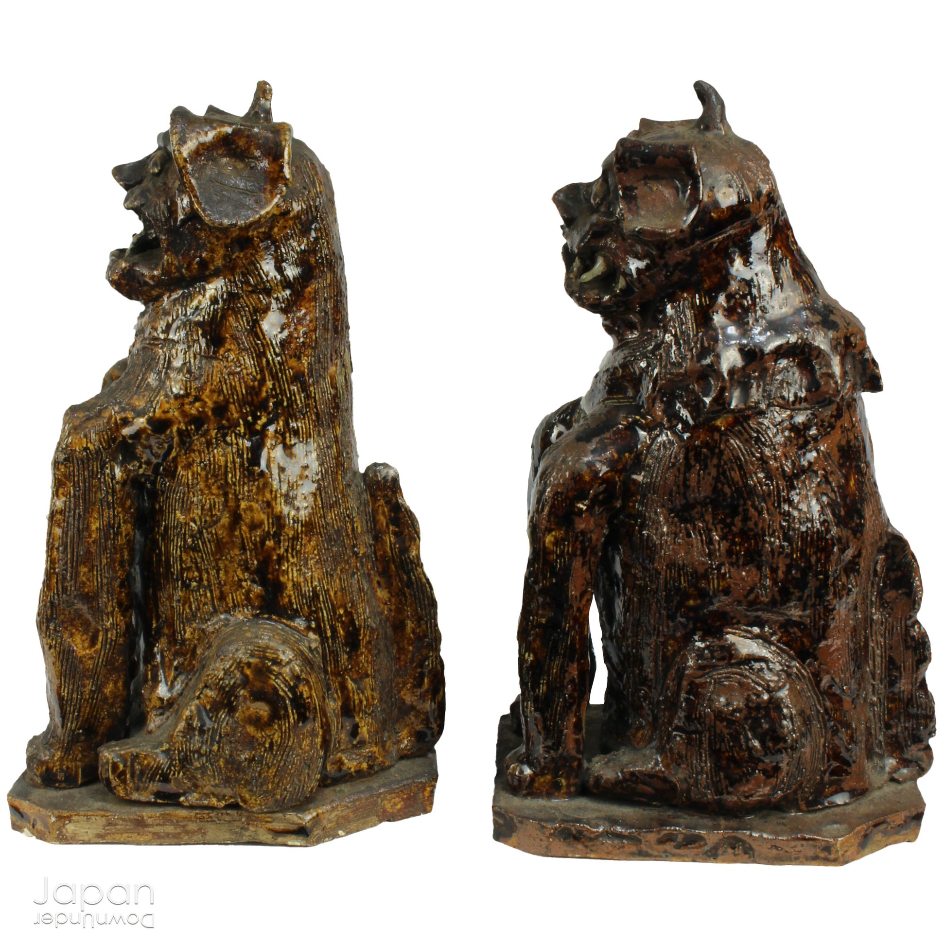 An enchanting duo of antique stoneware lion dogs, known as komainu. Believed to ward off evil, these guardians stand watch at the entrance of Shinto shrines, and will add a touch of mystique to your decor. Handcrafted with intricate details, the lion dogs are sure to bring a sense of protection and tradition to your space.