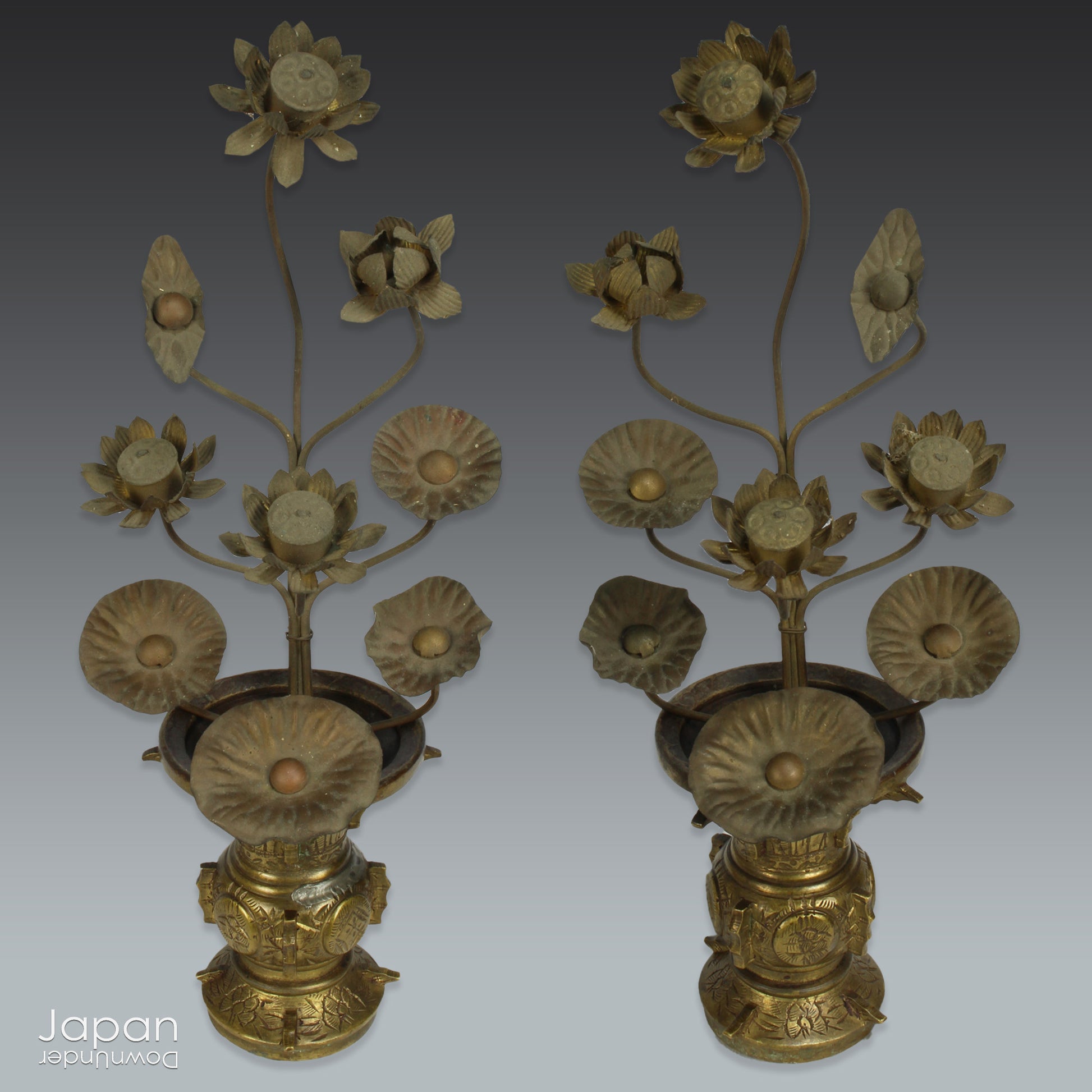 Infuse your home with serenity and grace with this exquisite pair of antique Buddhist lotus flower altar arrangements. These meticulously crafted metal flowers, known as Jouka, meaning "eternal flowers,” are a stunning representation of spiritual beauty. Set in decorative vases, these unique pieces offer a tranquil energy that will elevate any room.
