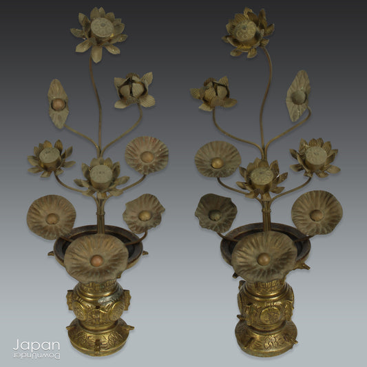 Infuse your home with serenity and grace with this exquisite pair of antique Buddhist lotus flower altar arrangements. These meticulously crafted metal flowers, known as Jouka, meaning "eternal flowers,” are a stunning representation of spiritual beauty. Set in decorative vases, these unique pieces offer a tranquil energy that will elevate any room.