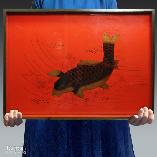 Step back in time and immerse yourself in the elegance of the past with this exquisite 1800s rare red lacquer tray, a true collector’s treasure. Featuring a Japanese black koi carp, painted finely in black and gold and swimming peacefully amongst river foliage, this stunningly large tray brings a touch of historical charm and sophistication to any space. Its intricate design is not just a visual delight but also a lucky symbol,  making it a captivating and meaningful addition to your home.