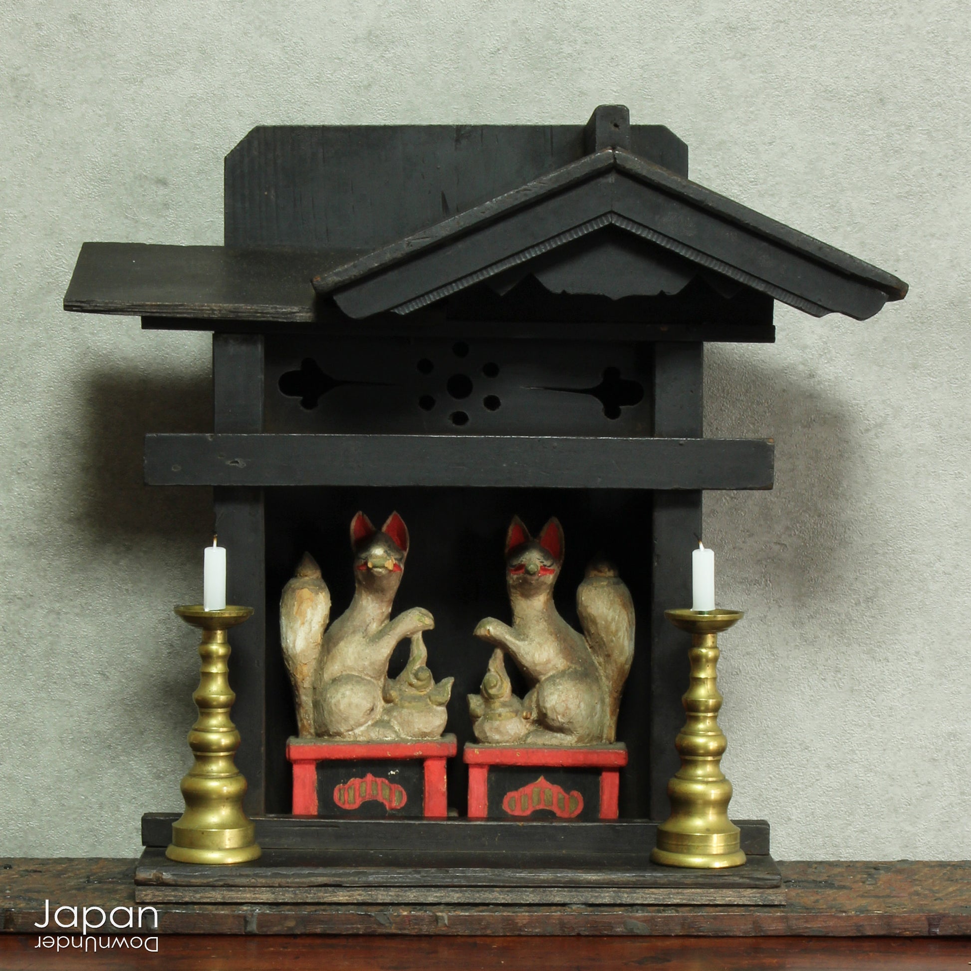 This charming Edo-period Shinto shrine is a rare and beautiful find - an authentic piece once cherished in a traditional Japanese country home. It originally held pride of place on the kamidana (god shelf), serving as a sacred site for daily offerings and prayers. Nestled within are a pair of hand-carved Inari foxes - protective spirits known to bring fortune, fertility, and blessings.