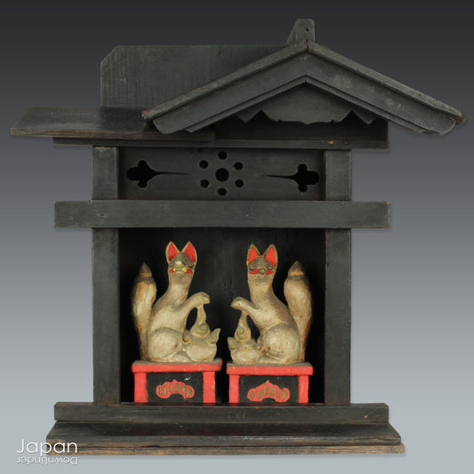 This charming Edo-period Shinto shrine is a rare and beautiful find - an authentic piece once cherished in a traditional Japanese country home. It originally held pride of place on the kamidana (god shelf), serving as a sacred site for daily offerings and prayers. Nestled within are a pair of hand-carved Inari foxes - protective spirits known to bring fortune, fertility, and blessings.