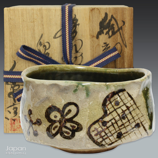 Immerse yourself in the art of tea with this breathtaking green Oribe ware matcha bowl. Handcrafted with delicate flower motifs and a timeless geometric design, this chawan effortlessly blends traditional elegance with natural beauty. The deep, earthy tones and thoughtful glazing make it the perfect addition to any tea ceremony, inviting you to connect with both the past and the present with each sip.