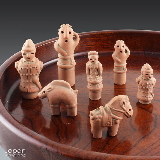 Discover a unique and charming collection of miniature Japanese funerary figures - haniwa - in this one-of-a-kind set. Each tiny piece is delicately handcrafted from terracotta, showcasing remarkable detail and traditional craftsmanship. Perfect for collectors or anyone with a love for Japanese history and art, these figures add a touch of quiet elegance to any decor.