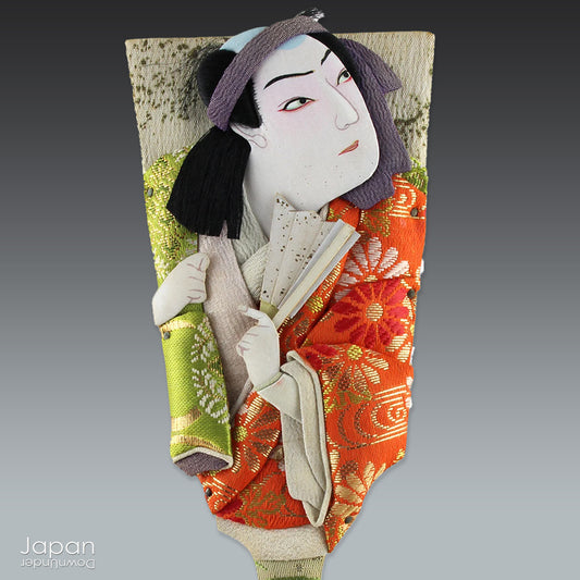 The hagoita has deep roots in Japanese New Year customs. Originally used in the game of hanetsuki - similar to badminton but played without a net - these paddles became symbolic protectors, their swift motion believed to dispel negative energy, much like the ceremonial gestures of a Shinto priest.