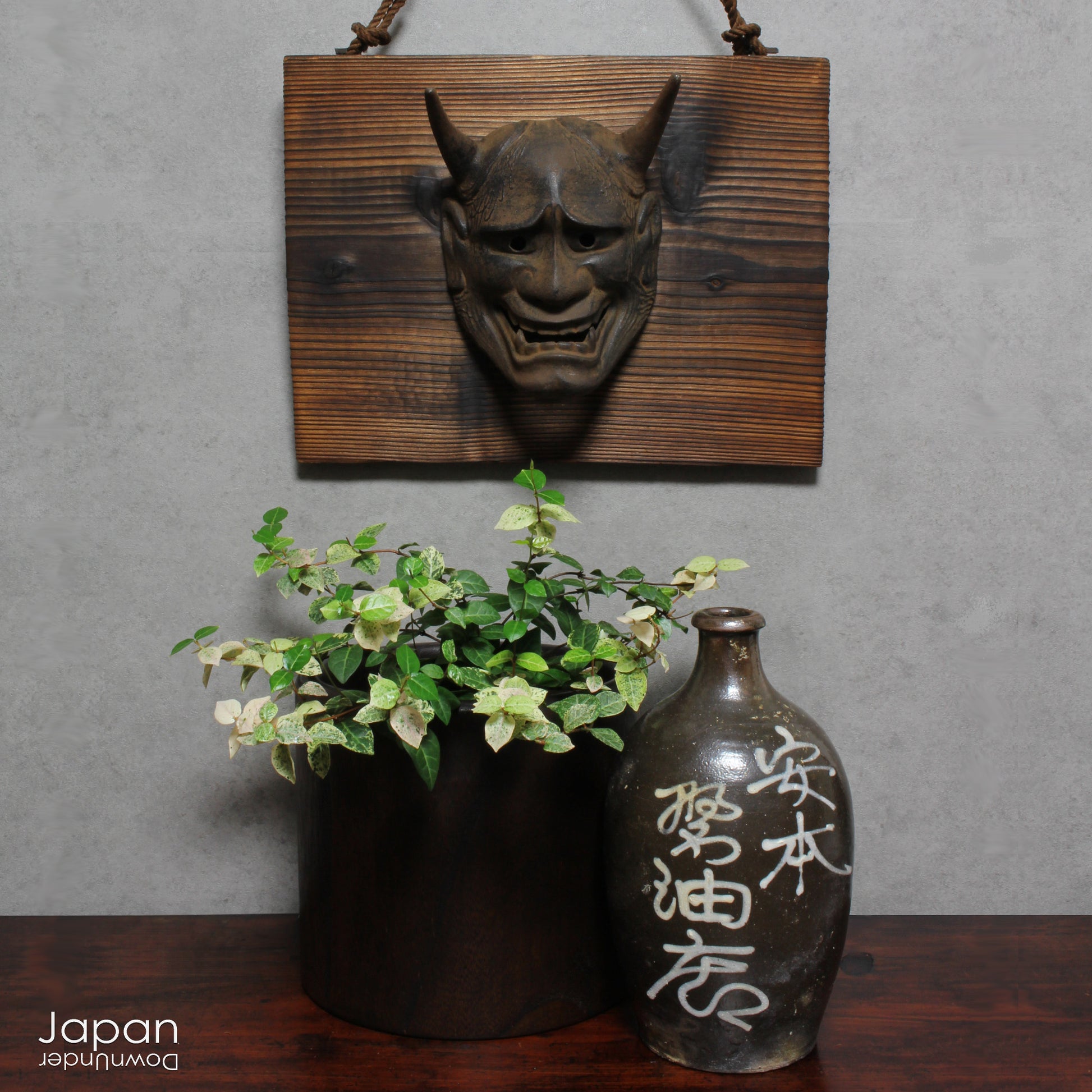 Enhance your space with this unique piece of Japanese folk art! A captivating old rusted bronze Hannya mask mounted on a charming rustic wood plaque - a truly wonderful addition to your wall decor. Infuse your home with the character and culture of this stunning find!