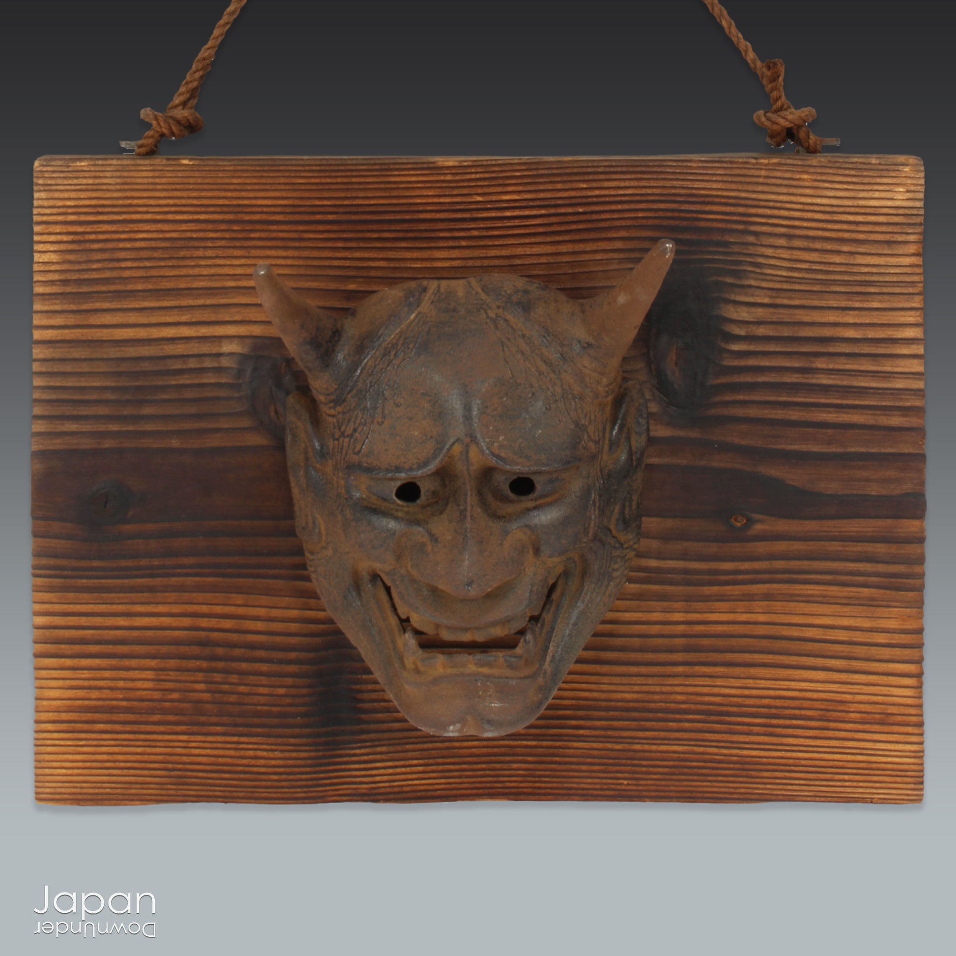 Enhance your space with this unique piece of Japanese folk art! A captivating old rusted bronze Hannya mask mounted on a charming rustic wood plaque - a truly wonderful addition to your wall decor. Infuse your home with the character and culture of this stunning find!