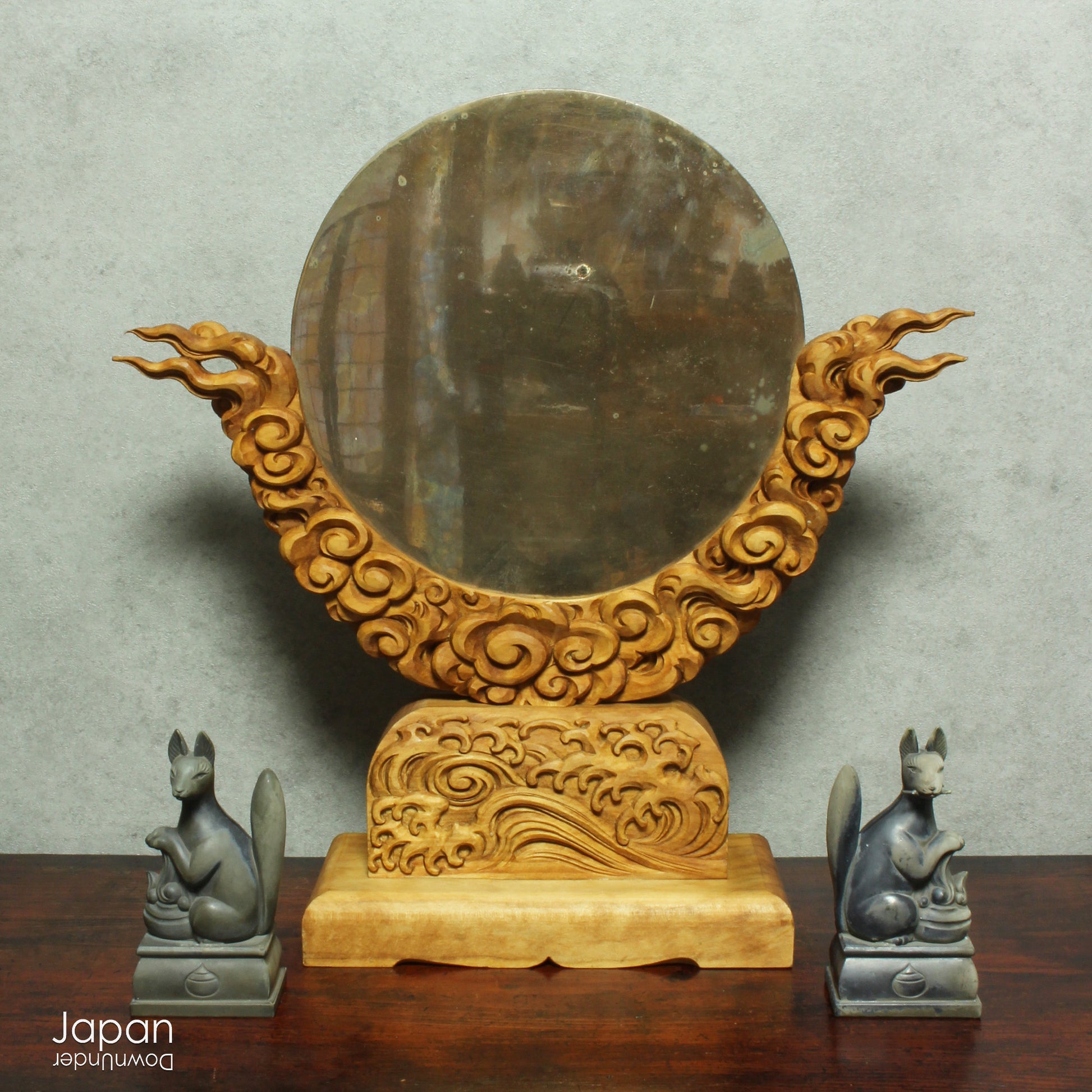 Enhance your spiritual space with this majestic rare antique Shinto shrine mirror. Resting on an intricately carved stand, this piece is a unique and beautiful addition to any sacred setting. Invite tranquility and elegance into your home with this spiritual space enhancer.