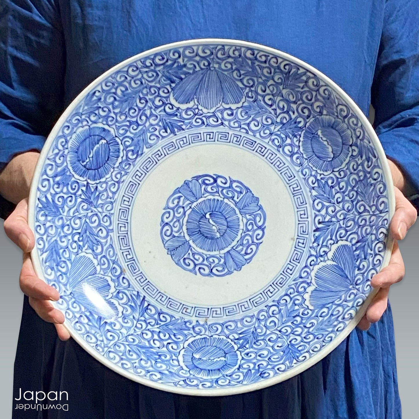 Transport yourself to the elegance of the Meiji era with this exquisite antique blue and white serving plate. Featuring an intricate karakusa (lucky vine) design, this stunning Imari plate will undoubtedly captivate any admirer of Japanese porcelain artistry. A perfect addition for collectors, it not only adds a touch of history and sophistication to your space, but also serves as a stylish way to present your favorite dishes.