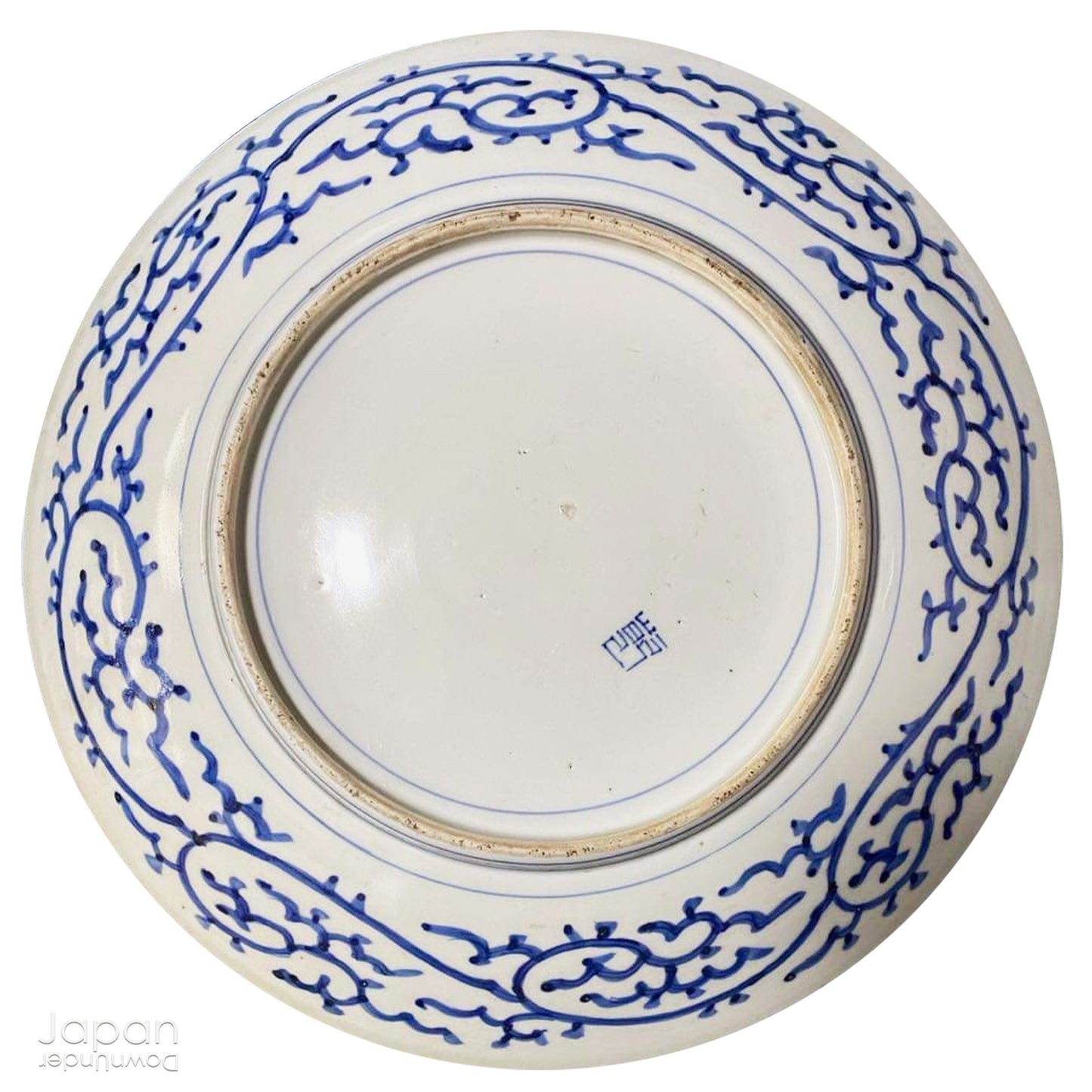 Transport yourself to the elegance of the Meiji era with this exquisite antique blue and white serving plate. Featuring an intricate karakusa (lucky vine) design, this stunning Imari plate will undoubtedly captivate any admirer of Japanese porcelain artistry. A perfect addition for collectors, it not only adds a touch of history and sophistication to your space, but also serves as a stylish way to present your favorite dishes.