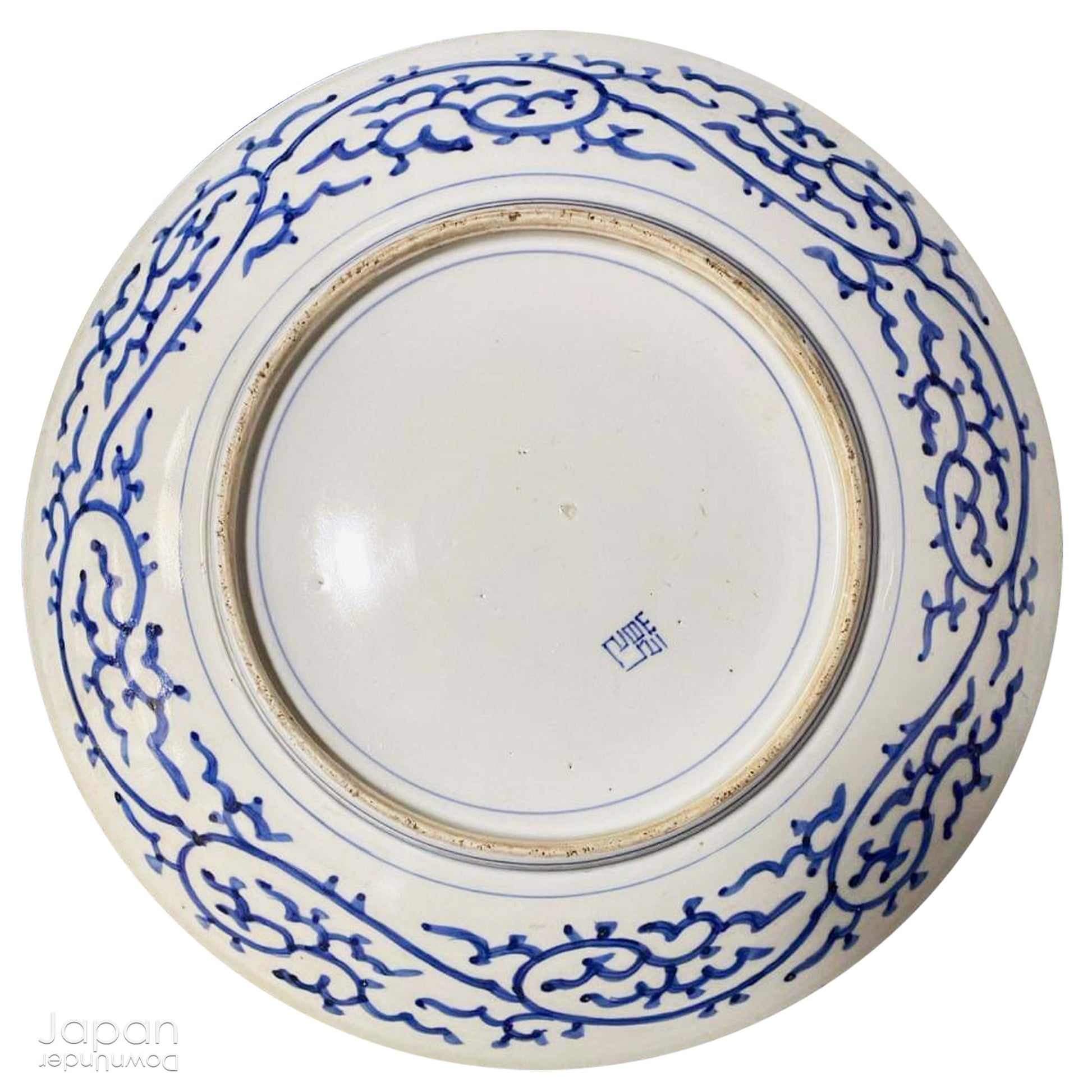 Transport yourself to the elegance of the Meiji era with this exquisite antique blue and white serving plate. Featuring an intricate karakusa (lucky vine) design, this stunning Imari plate will undoubtedly captivate any admirer of Japanese porcelain artistry. A perfect addition for collectors, it not only adds a touch of history and sophistication to your space, but also serves as a stylish way to present your favorite dishes.