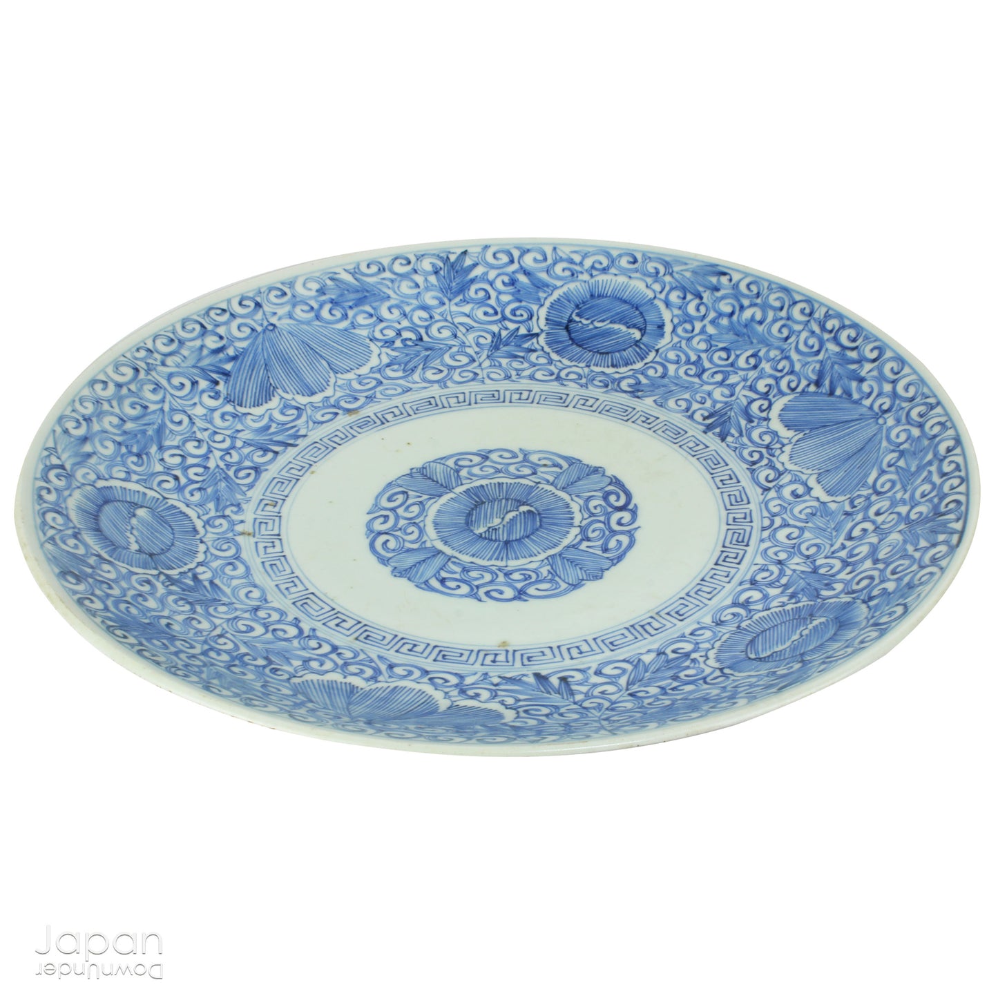 Transport yourself to the elegance of the Meiji era with this exquisite antique blue and white serving plate. Featuring an intricate karakusa (lucky vine) design, this stunning Imari plate will undoubtedly captivate any admirer of Japanese porcelain artistry. A perfect addition for collectors, it not only adds a touch of history and sophistication to your space, but also serves as a stylish way to present your favorite dishes.