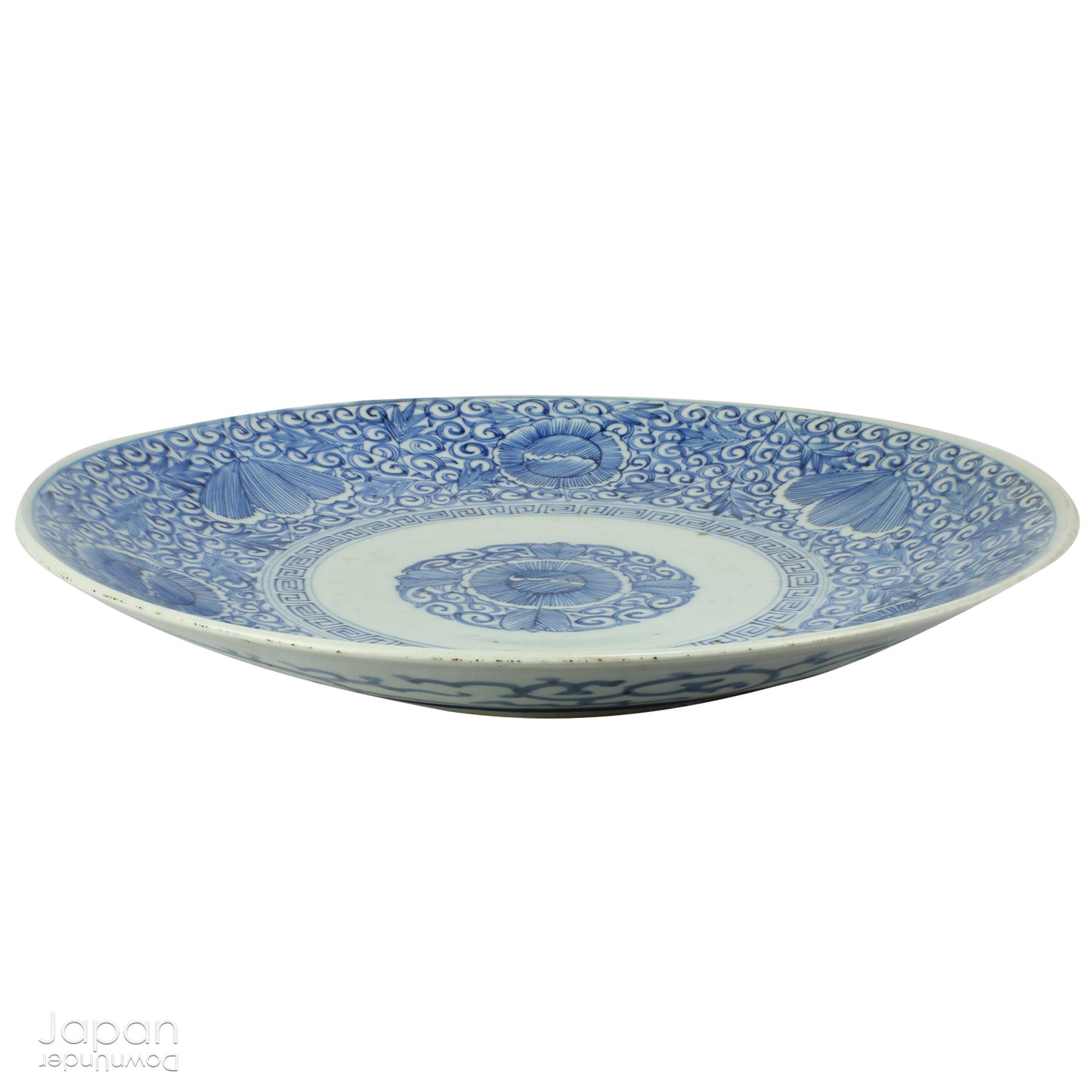Transport yourself to the elegance of the Meiji era with this exquisite antique blue and white serving plate. Featuring an intricate karakusa (lucky vine) design, this stunning Imari plate will undoubtedly captivate any admirer of Japanese porcelain artistry. A perfect addition for collectors, it not only adds a touch of history and sophistication to your space, but also serves as a stylish way to present your favorite dishes.