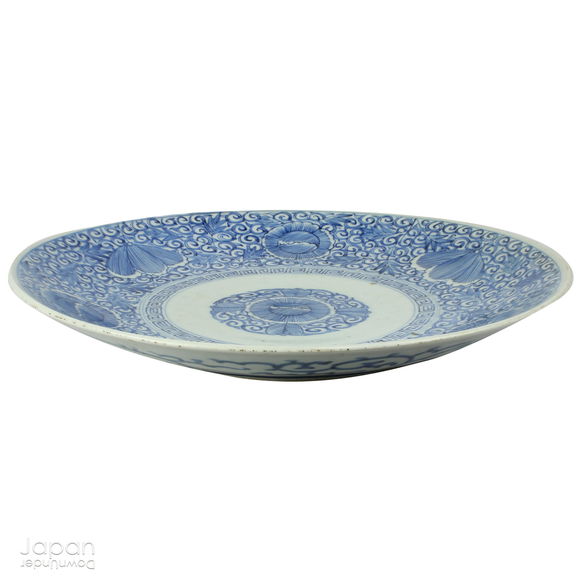 Transport yourself to the elegance of the Meiji era with this exquisite antique blue and white serving plate. Featuring an intricate karakusa (lucky vine) design, this stunning Imari plate will undoubtedly captivate any admirer of Japanese porcelain artistry. A perfect addition for collectors, it not only adds a touch of history and sophistication to your space, but also serves as a stylish way to present your favorite dishes.