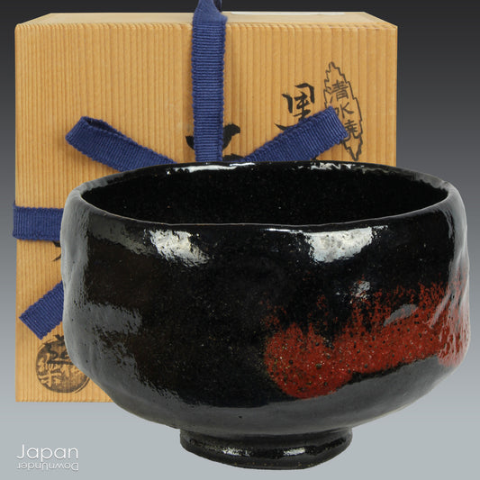 Elevate your tea experience with this stunning vintage black raku ware matcha tea bowl, a timeless work of art that brings both beauty and sophistication to every sip. Handcrafted in Kyoto, Japan, this elegant bowl features a striking contrast between the glossy black glaze and subtle reddish-brown accents that emerge randomly across the surface - each one a testament to the artistry and uniqueness of the raku firing process.