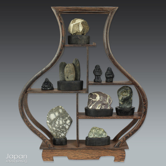 Elevate your home decor with this striking, modern collection of vintage Japanese miniature suiseki stones, beautifully arranged on a handcrafted, vase-shaped segmented shelf. These naturally sculpted stones evoke the essence of serene landscapes and bring a sense of harmony, sophistication, and contemplative stillness to any space.