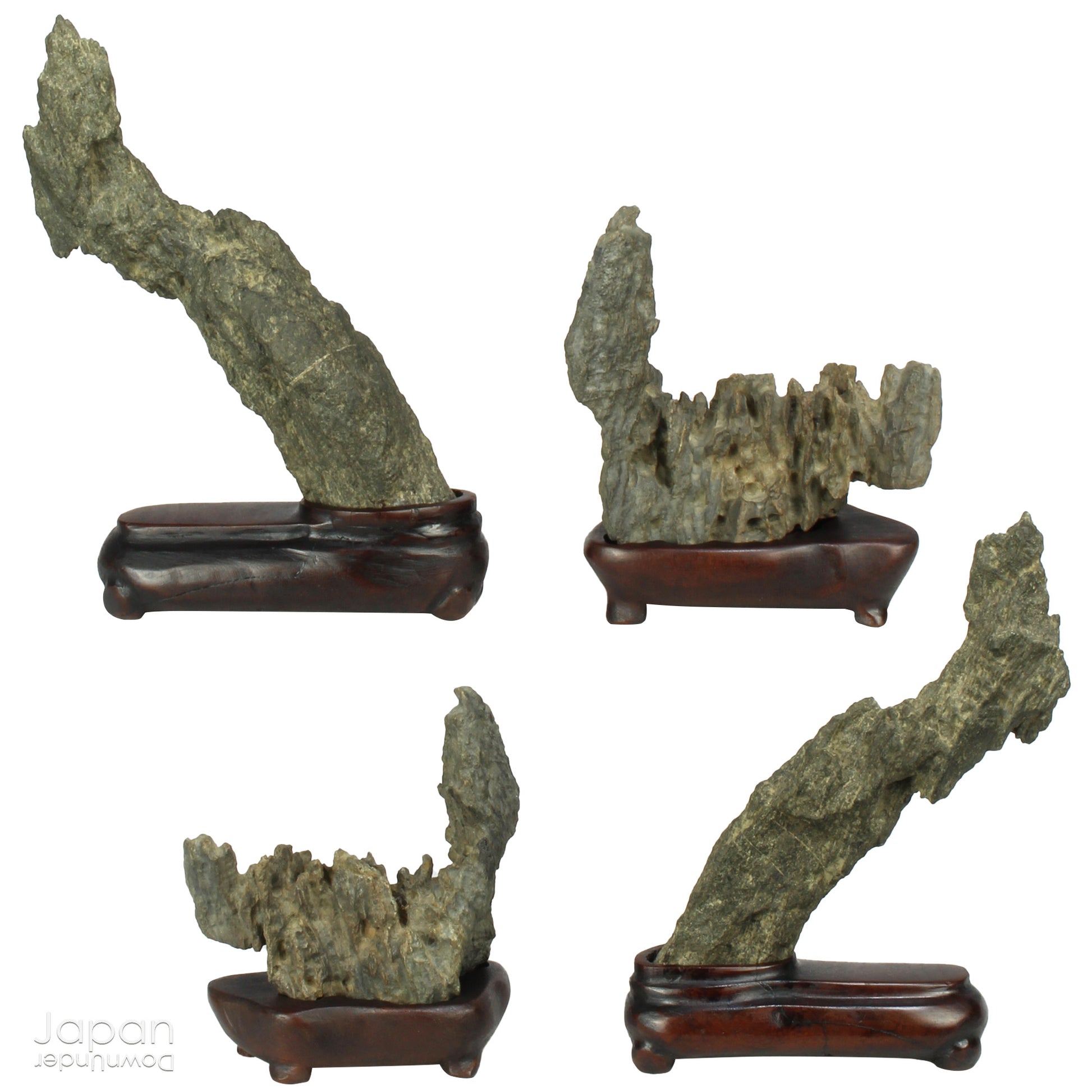 Invite serenity and understated beauty into your space with this remarkable collection of seven vintage miniature Japanese suiseki - natural “water stones” cherished for their quiet symbolism and evocative forms. Each small stone rests atop a finely hand-carved ebony daiza (stand), thoughtfully crafted to support and elevate its unique presence.