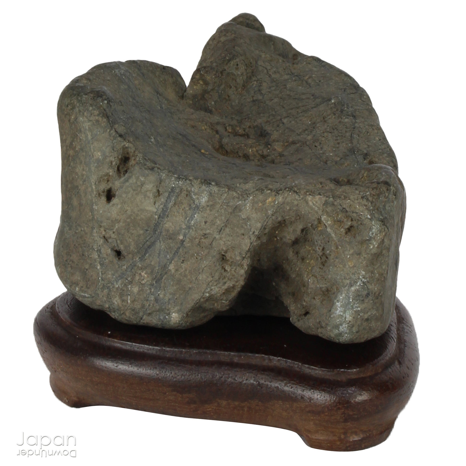 This vintage Japanese suiseki offers a quiet meditation on nature’s artistry ;a naturally weathered stone that embodies stillness, grace, and introspection. Resting atop an intricately hand-carved daiza, it invites the viewer into a space of reflection and reverence, where simplicity holds profound depth.