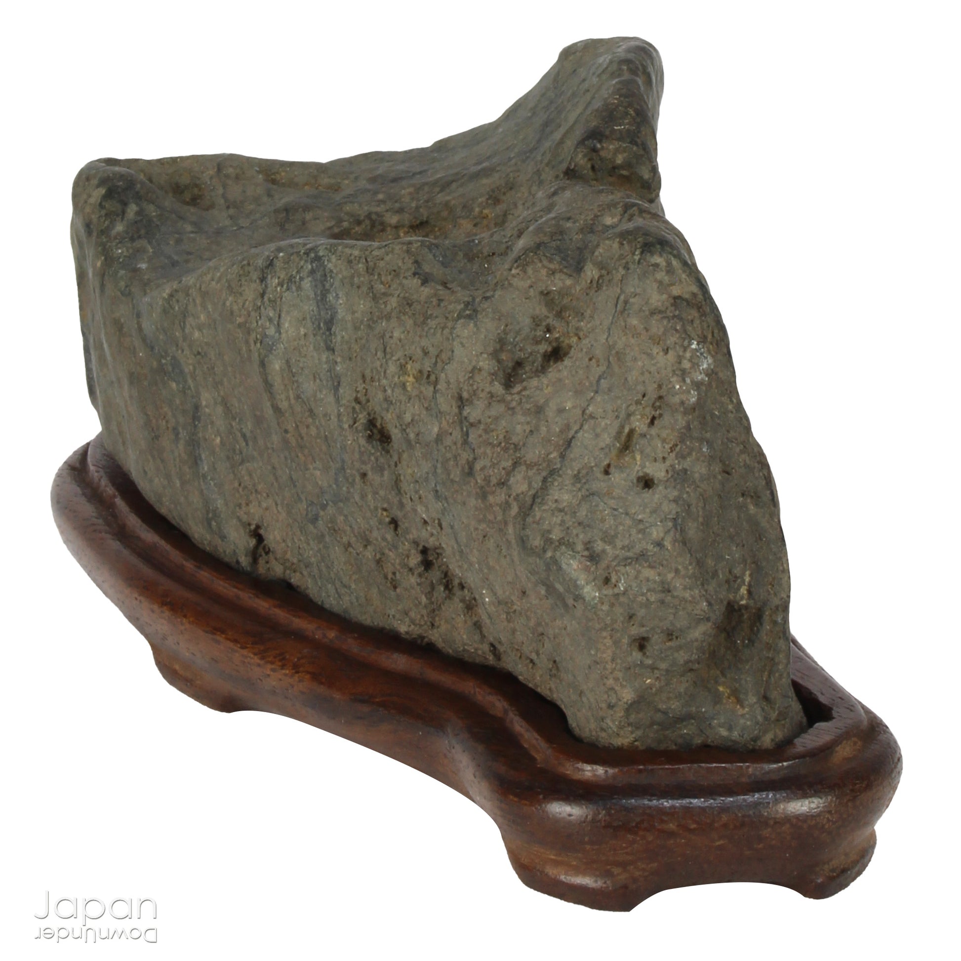 This vintage Japanese suiseki offers a quiet meditation on nature’s artistry ;a naturally weathered stone that embodies stillness, grace, and introspection. Resting atop an intricately hand-carved daiza, it invites the viewer into a space of reflection and reverence, where simplicity holds profound depth.