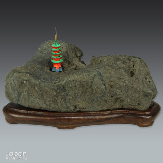 This vintage Japanese suiseki offers a quiet meditation on nature’s artistry ;a naturally weathered stone that embodies stillness, grace, and introspection. Resting atop an intricately hand-carved daiza, it invites the viewer into a space of reflection and reverence, where simplicity holds profound depth.