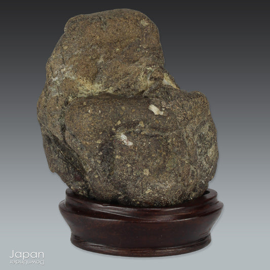 Channel the quiet power of nature with this captivating miniature suiseki, a natural stone art form deeply rooted in Japanese tradition. Resting gracefully on a hand-carved wooden daiza (base), this piece exudes a contemplative presence - ideal for spaces devoted to mindfulness, creative thought, or serene display.
