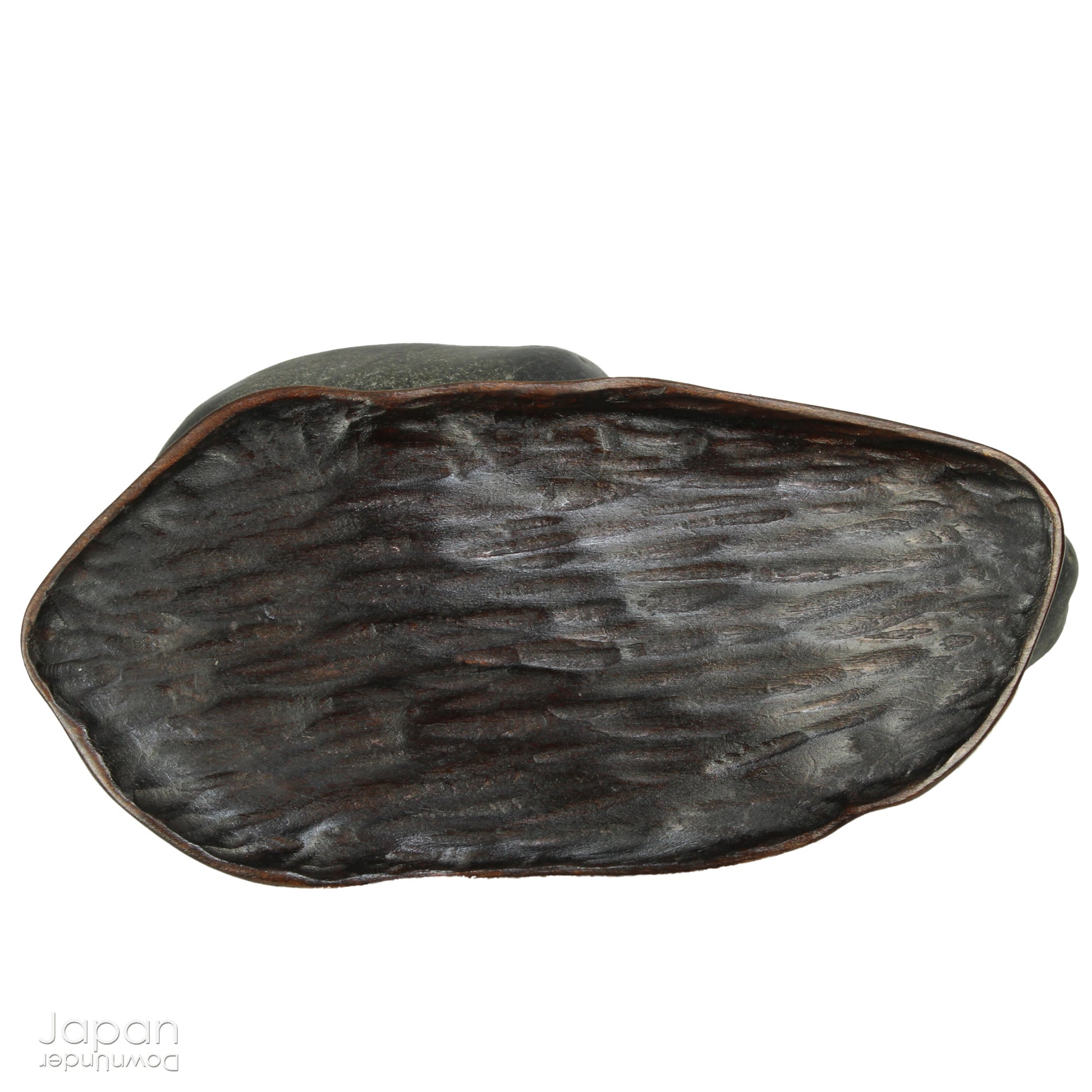 Introduce a quiet elegance and poetic depth to your space with this vintage Japanese suiseki - a contemplative stone shaped by nature and imbued with a serene, spiritual aura. Resting on a finely hand-carved daiza (wooden base) and accompanied by a small metal pagoda, this piece emanates stillness, balance, and an understated visual allure.