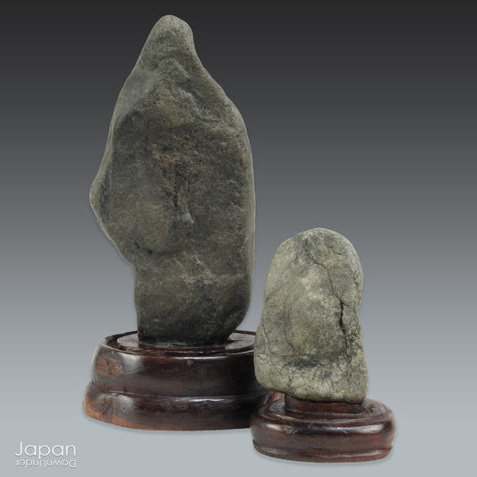 Invite a sense of contemplative calm into your space with this evocative pair of vintage Japanese suiseki - natural stones shaped by the slow, patient hands of time. Rooted in the Japanese aesthetic traditions of wabi-sabi and the reverence for impermanence, these stones are more than mere objects; they are landscapes in miniature, vessels of stillness, and silent poems composed by nature itself.