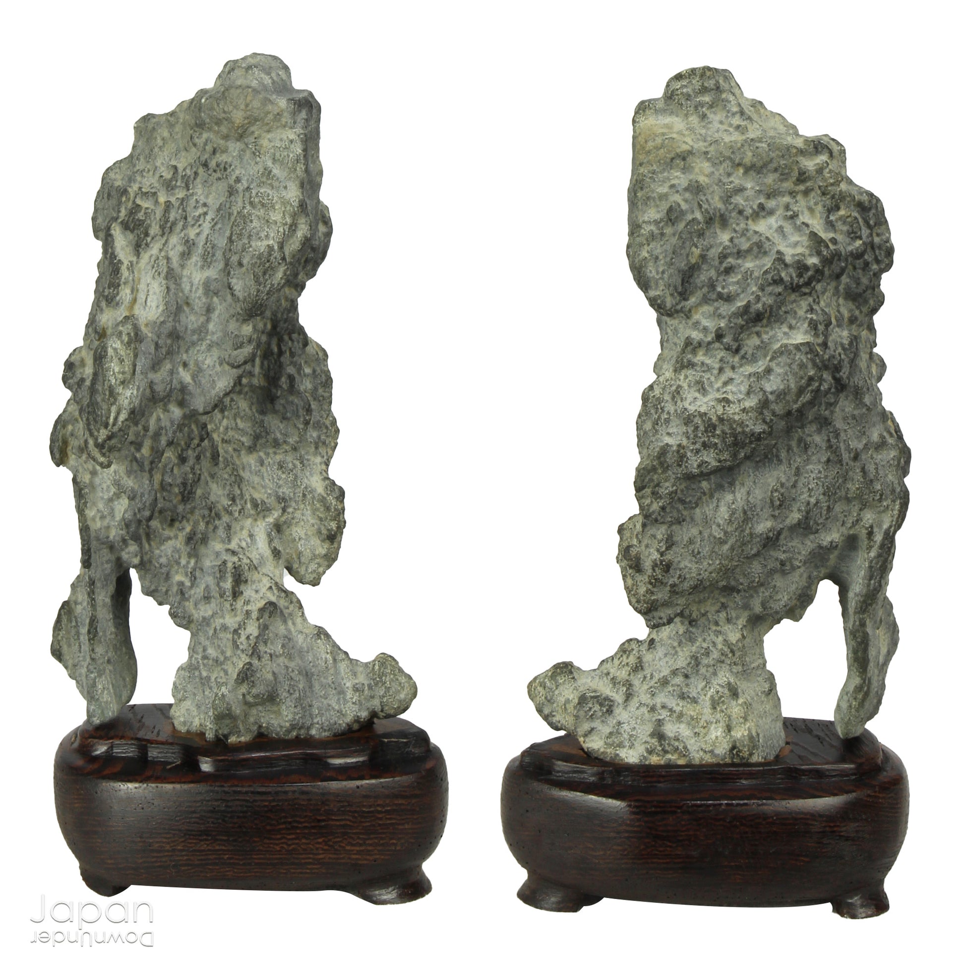 Invite serenity and understated beauty into your space with this remarkable collection of seven vintage miniature Japanese suiseki - natural “water stones” cherished for their quiet symbolism and evocative forms. Each small stone rests atop a finely hand-carved ebony daiza (stand), thoughtfully crafted to support and elevate its unique presence.