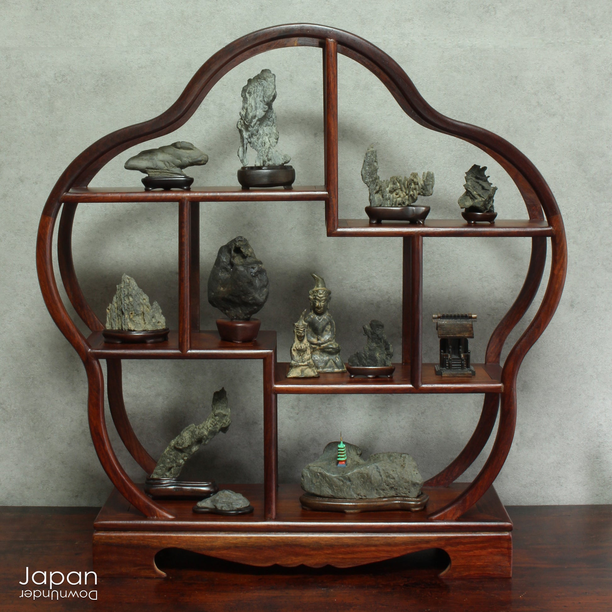 Invite serenity and understated beauty into your space with this remarkable collection of seven vintage miniature Japanese suiseki - natural “water stones” cherished for their quiet symbolism and evocative forms. Each small stone rests atop a finely hand-carved ebony daiza (stand), thoughtfully crafted to support and elevate its unique presence.