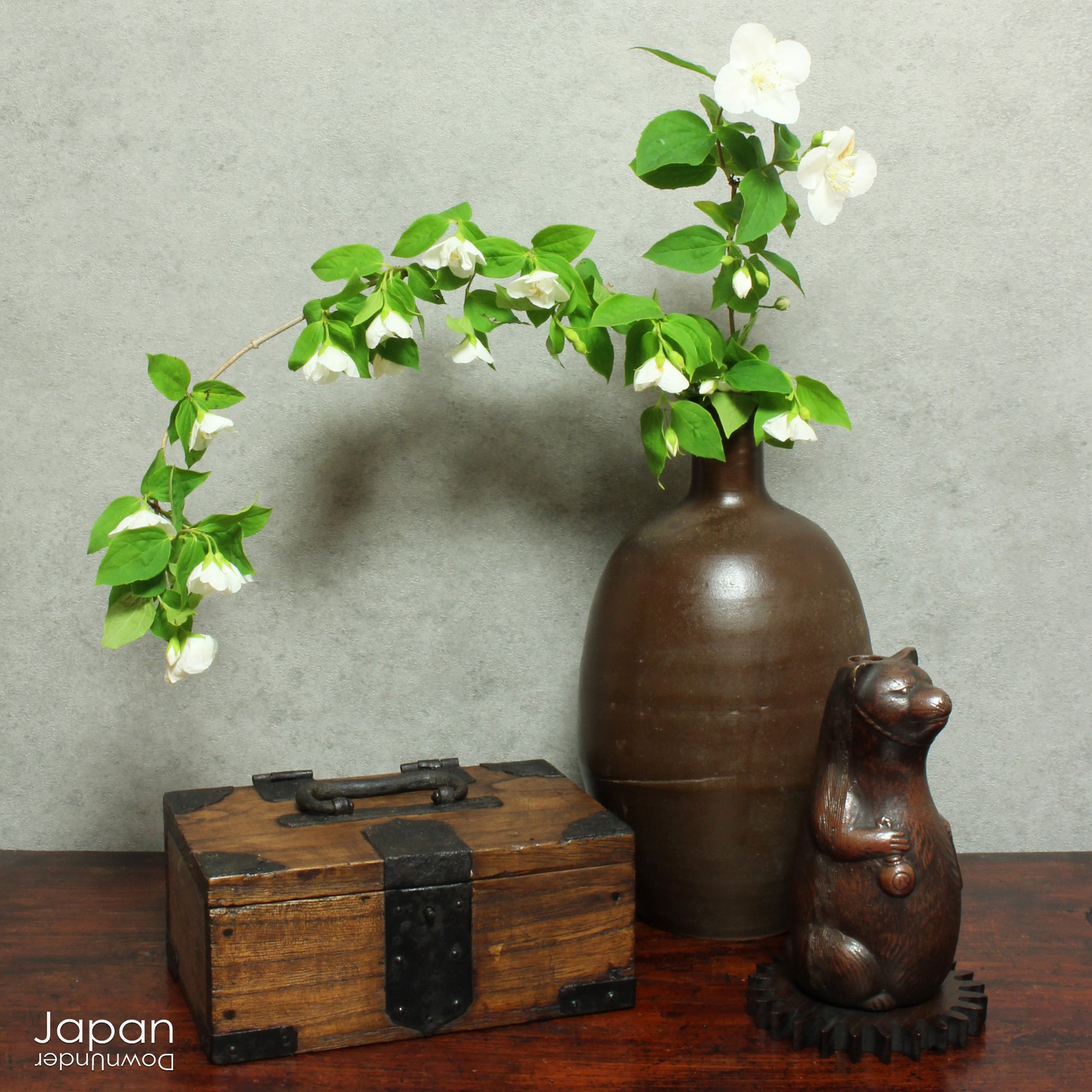 Infuse your space with the timeless elegance of Japanese craftsmanship and folklore through this antique Bizen raccoon dog tokkuri. Not only does it serve its traditional function as a sake pourer, but it also doubles as a captivating piece of art or a charming bud vase, making it a truly versatile addition to your collection.