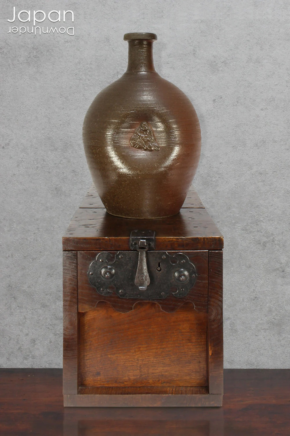 Add depth and story to your interior with this striking Taisho-era Bizen ware sake tokkuri, adorned with Hotei - the cheerful god of happiness, children, and good fortune, and one of Japan’s beloved Seven Lucky Gods. More than just a vessel, this antique bottle is a captivating example of Japanese folk craftsmanship, equally compelling as a sculptural display piece or a uniquely soulful vase.