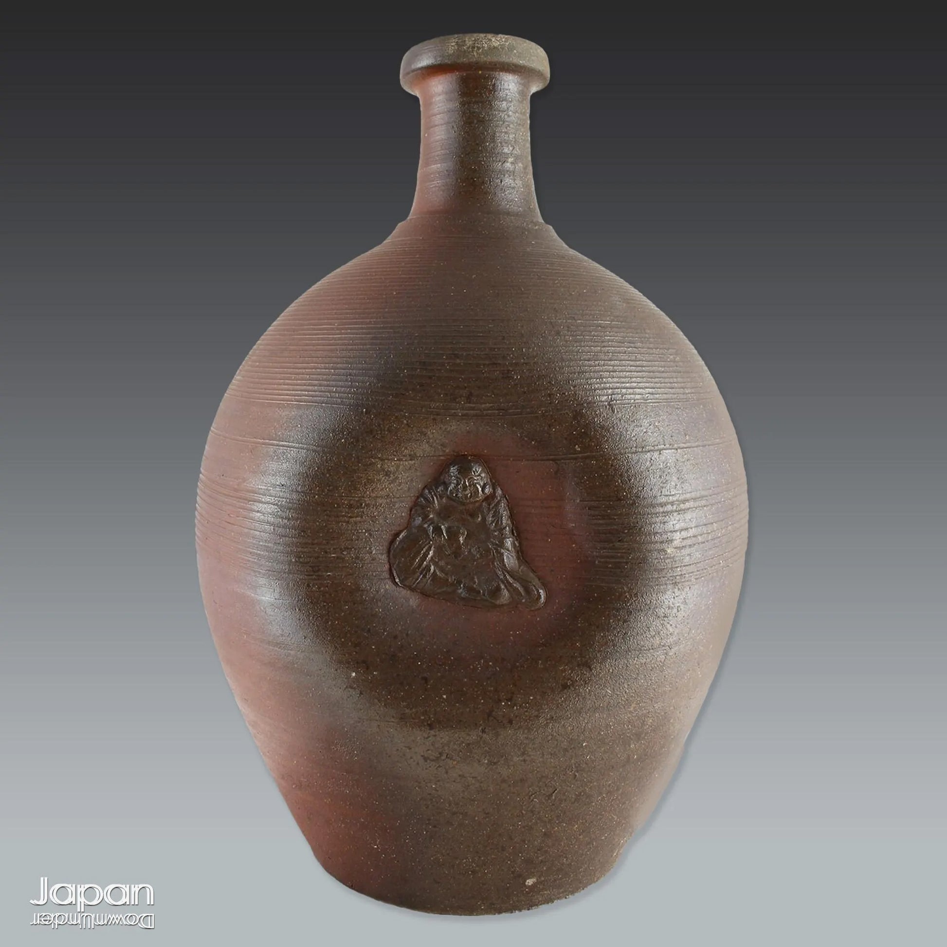 Add depth and story to your interior with this striking Taisho-era Bizen ware sake tokkuri, adorned with Hotei - the cheerful god of happiness, children, and good fortune, and one of Japan’s beloved Seven Lucky Gods. More than just a vessel, this antique bottle is a captivating example of Japanese folk craftsmanship, equally compelling as a sculptural display piece or a uniquely soulful vase.